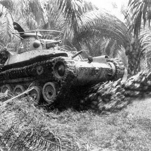 MALAYSIA - JANUARY 01:     A Japanese Imperial Army tank proceeds with falling palm trees toward Singapore circa 1942 in Malaysia.  (Photo by The Asahi Shimbun via Getty Images)